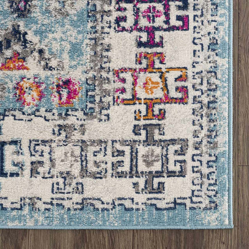 Close-up of the Tigris Turquoise 2314 rug. Features a geometric pattern in ivory, light blue, pink, and orange. Swatch