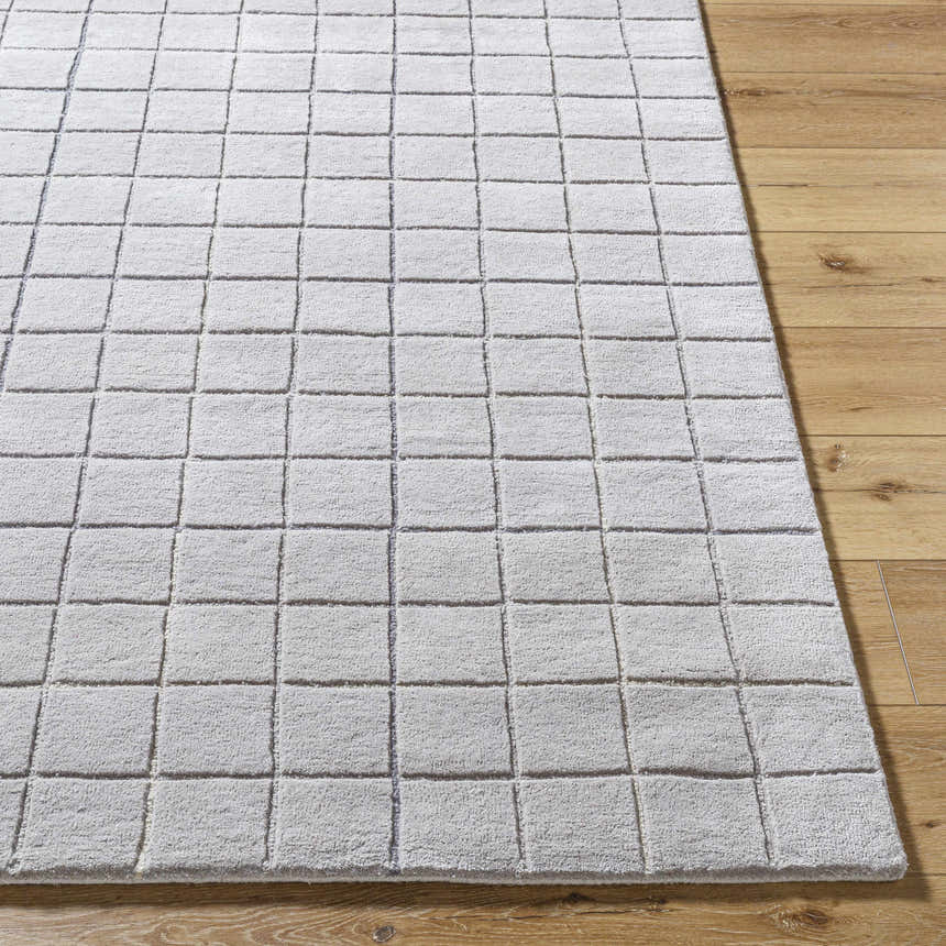 Close-up of the hand-tufted Toshi Sterling Gray Area Rug, featuring a contemporary square block pattern and soft wool texture. Front