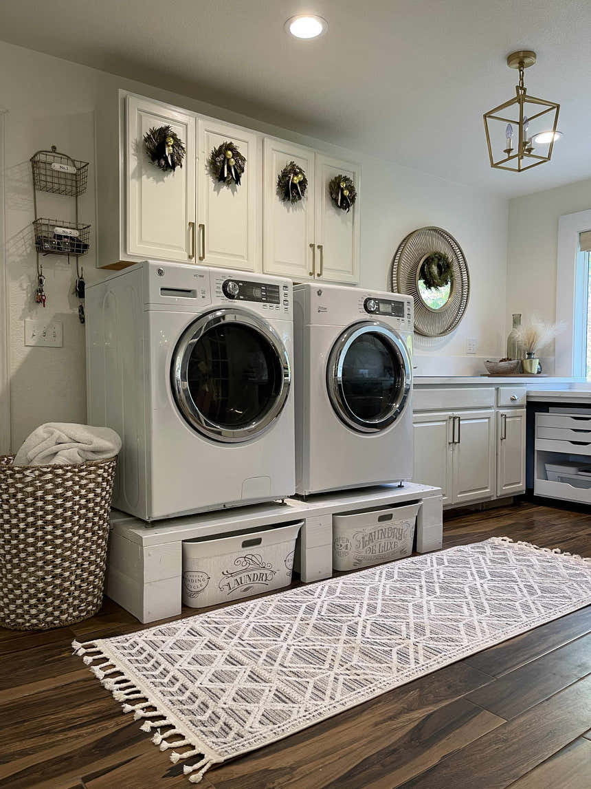 Farmhouse laundry room with Magnolia Beige 2301 Area Rug runner, white cabinets, wood floors, and laundry basket. Roomscene-Runner