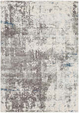Close-up of the Tonalea Carved Statement Area Rug. Abstract pattern in shades of gray, ivory, and blue. Machine woven texture. Design-Rectangle-582