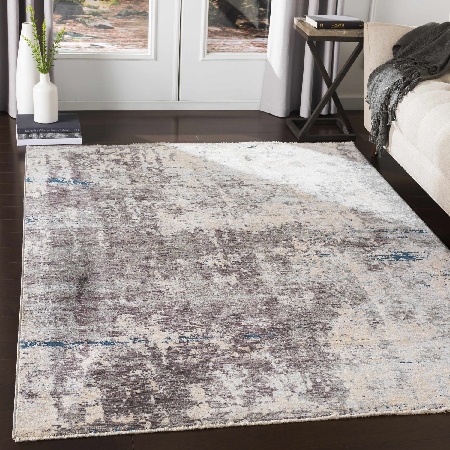 Living room scene with a Tonalea Carved Statement Area Rug in blue, charcoal, and ivory, under a sofa and side table. Roomscene-Rectangle