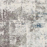 Close-up of the Tonalea Carved Statement Area Rug. Abstract design in ivory, gray, charcoal, and hints of blue. Soft texture. Swatch