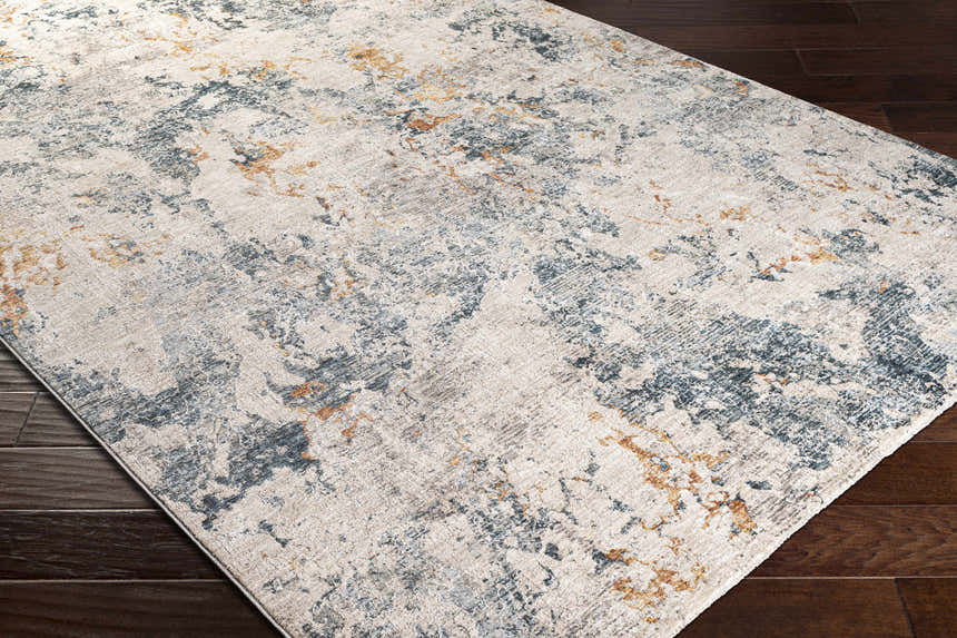 Close-up of the Tracyton Area Rug showing a cream, teal, and mustard abstract design on dark wood floors. Corner