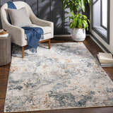 Living room scene with a neutral armchair and the Tracyton Area Rug in brick red, cream, dusty sage, and gray. Roomscene-Rectangle
