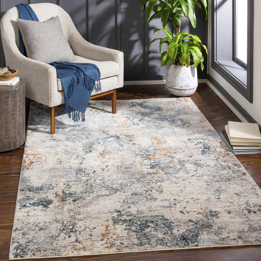 Living room scene with a neutral armchair and the Tracyton Area Rug in brick red, cream, dusty sage, and gray. Roomscene-Rectangle