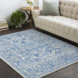 Living room scene with beige sofa and blue and beige Truxton Area Rug adding a vintage, bohemian touch. Roomscene-Rectangle