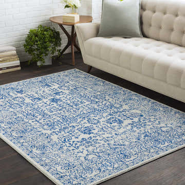 Living room scene with beige sofa and blue and beige Truxton Area Rug adding a vintage, bohemian touch. Roomscene-Rectangle