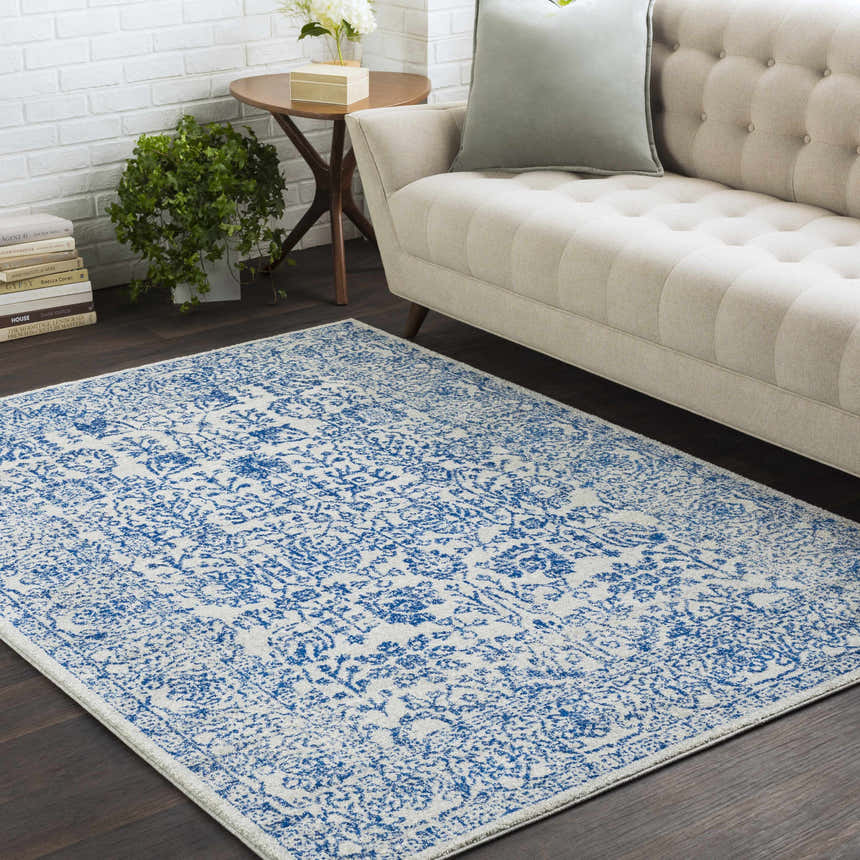 Living room scene with beige sofa and blue and beige Truxton Area Rug adding a vintage, bohemian touch. Roomscene-Rectangle