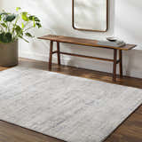 Entryway with a Tut Textured Luxe Rug, wood bench, mirror, and potted plant. Roomscene-Rectangle