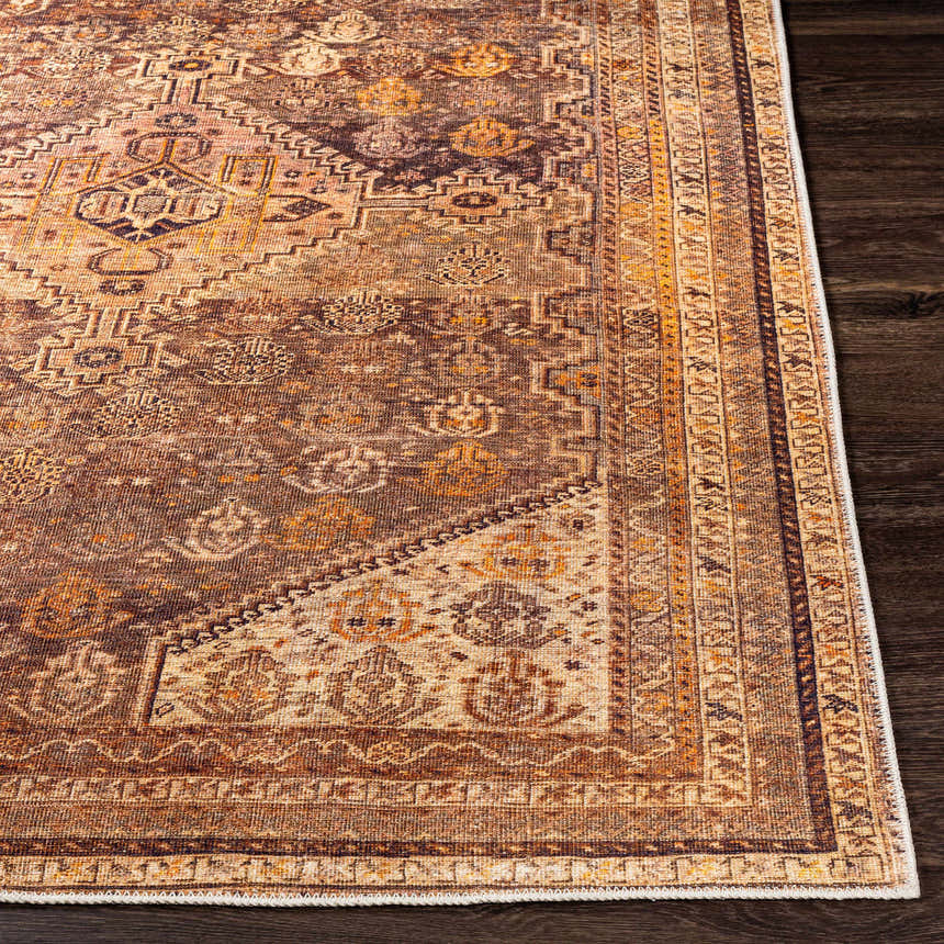 Close-up of the Tungao Washable Area Rug. Bohemian style rug with brown, burnt orange, light beige, and saffron colors. Front