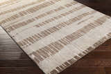 Close-up of the Turbeville Premium Area Carpet. Dark brown and light beige stripes on a hand-knotted wool rug. Corner