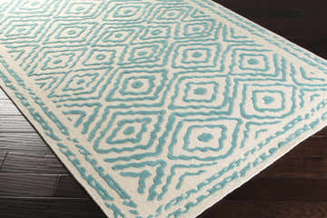Close-up of Tuskahoma Premium Area Carpet with aqua geometric pattern on light beige wool, hand-knotted texture. Corner