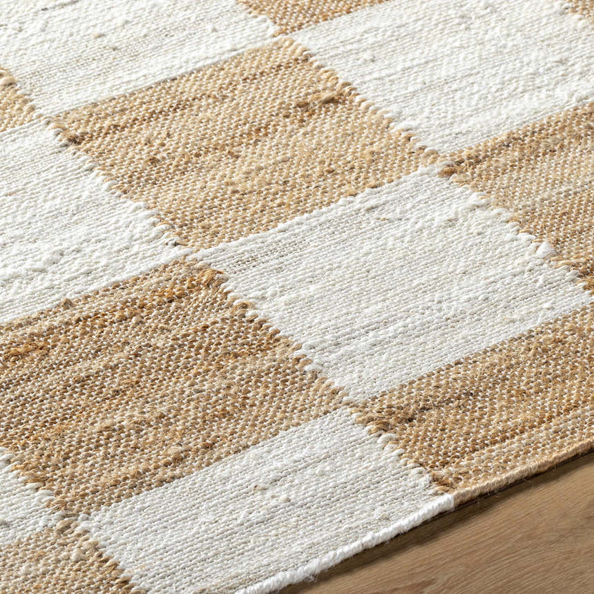 Close-up of the hand woven Tyhir Checkered Jute Rug. Light brown and light slate jute create a farmhouse checkered pattern. Texture