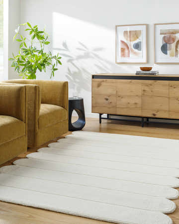 Living room scene with mustard chairs and a light silver Tayte White Abstract Area Rug. Roomscene-Rectangle