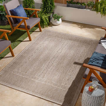 Outdoor patio scene with wood chairs and the Unidos Beige Area Rug. Roomscene-Rectangle