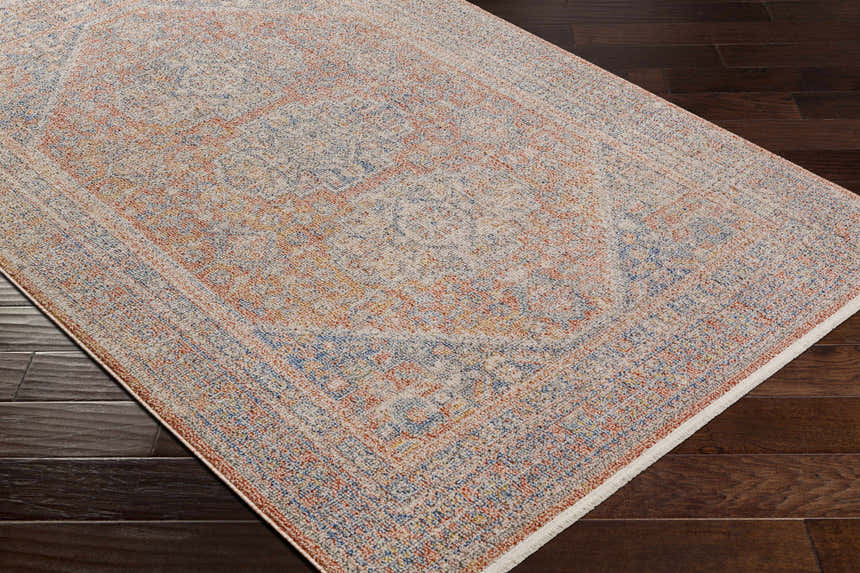 Close-up of the Vahn Area Rug showing its traditional oriental pattern and colors like dark blue, ivory, and red. Corner