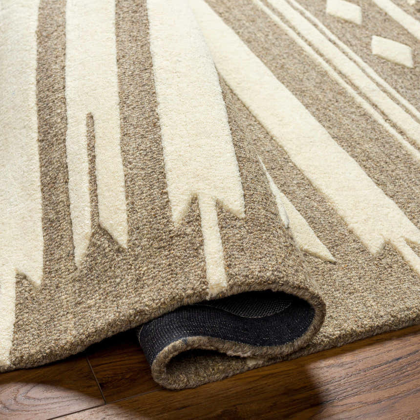 Close-up of the hand-tufted Vamo Area Rug. Brown and oatmeal geometric design, 100% wool texture. Clearance rug. Fold