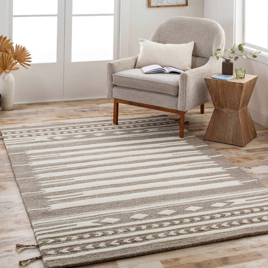 Living room scene with a Vamo Area Rug in brown, tan, and oatmeal colors, styled with a chair and side table. Roomscene-Rectangle