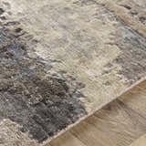 Close-up of the hand-knotted Vincentown Area Rug. Viscose rug in charcoal, brown, denim, and gray with a contemporary design. Texture