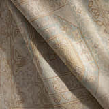 Close-up of the hand-knotted Villareal Area Rug showing its cream, beige, and ice blue traditional pattern and wool texture. Fold