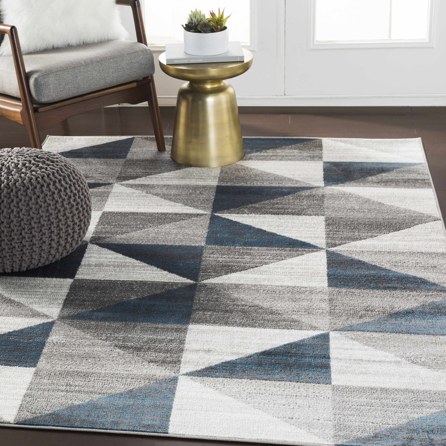 Living room scene with blue and gray Volant Area Rug, modern chair, and gold accent table. Roomscene-Rectangle
