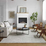 Living room with a Vernonia Area Rug in black and ivory, sofa, chairs, and fireplace. Roomscene-Rectangle