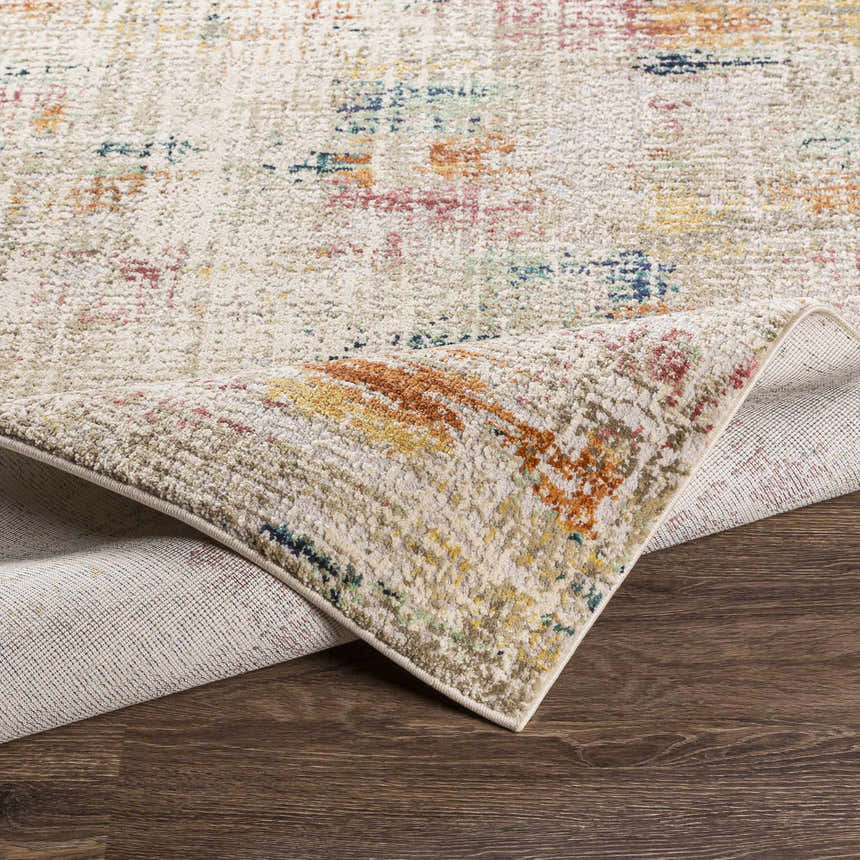 Close-up of the Eversley Area Rug showing cream, blue, pink, and mustard colors with a textured, machine-woven design. Fold