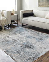 Living room scene with a Vesna Blue Area Rug, light sofa, dark wood floors, and neutral decor. Roomscene-Rectangle