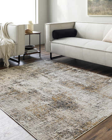 Living room scene with a Vesna area rug in charcoal, ivory, and mustard colors under a modern white sofa. Roomscene-Rectangle