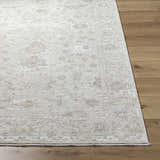 Close up of the light silver Vaman Luxe Rug showing its traditional floral pattern and texture. Front