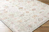 Close-up of the Verna Area Rug showing its traditional pattern, dark brown, dusty coral, gray, and ivory colors. Corner