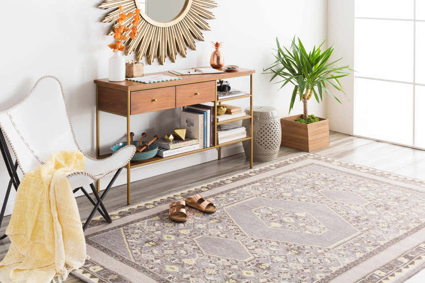 Styled room featuring the Walden Area Rug. Hand-knotted wool rug in gray, beige, and yellow with a traditional geometric pattern. Roomscene-Rectangle