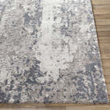Close-up of the Walhonding Area Rug, a contemporary rug in denim, ivory, light gray, and medium gray on wood flooring. Front