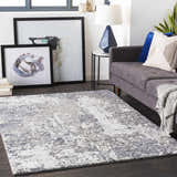 Living room scene with a gray sofa and the denim and ivory Walhonding Area Rug. Roomscene-Rectangle