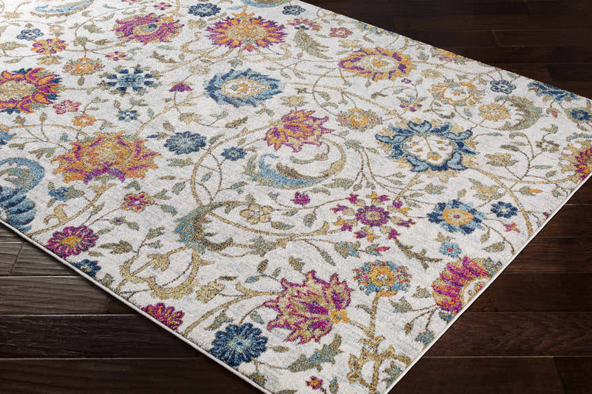 Close-up of the Walsenburg Floral Rug, a machine-woven rug with a light beige background and colorful floral pattern. Corner