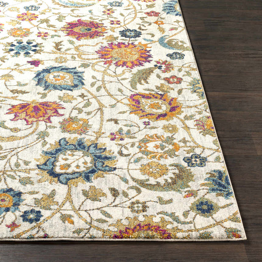 Close-up of the Walsenburg Floral Rug. Features a light beige background with navy, teal, and mustard floral patterns. Front