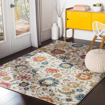 Bright living room with Walsenburg Floral Rug, yellow cabinet, white chair and pouf. Roomscene-Rectangle