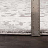 Close up of the pile height of the Watford Updated Traditional Tibetan Rug. Charcoal, gray, and ivory tones. Pile