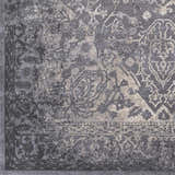 Close-up of the charcoal, gray, and ivory Watford Updated Traditional Tibetan Rug, showing its vintage-inspired pattern. Swatch