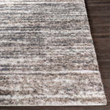 Close-up of the Weddin Striped Plush Area Rug showing charcoal, cream, gray, and tan stripes and soft, shaggy texture. Front