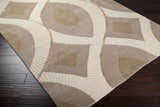 Close-up of the Weleetka Area Carpet, a hand-knotted wool rug with a contemporary geometric pattern in beige and cream. Corner