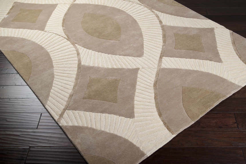 Close-up of the Weleetka Area Carpet, a hand-knotted wool rug with a contemporary geometric pattern in beige and cream. Corner