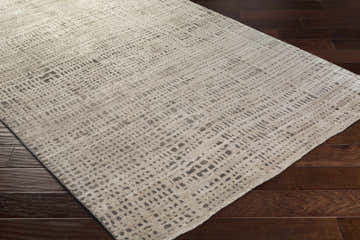 Close-up of the hand-knotted Wellsboro Carpet. Viscose rug with a farmhouse style pattern in neutral beige and gray tones. Corner