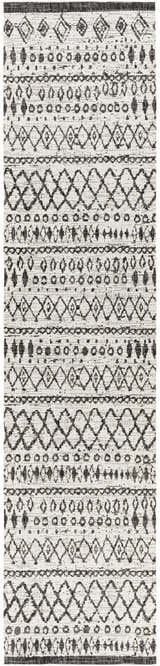 Close-up of the Westside Outdoor Area Rug. Black and white rug with a woven bohemian-inspired geometric pattern. Design-Runner-2710
