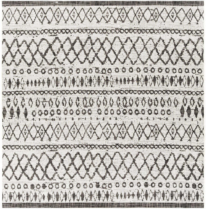 Close-up of the Westside Outdoor Area Rug. Black and white rug with a bohemian geometric pattern. Machine woven polypropylene texture. Design-Square-67