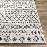 Close-up of the Westside Outdoor Area Rug. Black and white bohemian pattern on a textured, machine-woven polypropylene rug. Front