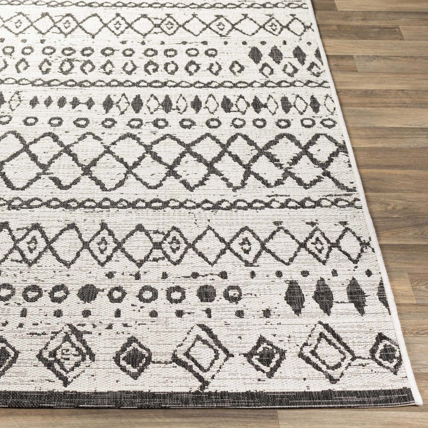 Close-up of the Westside Outdoor Area Rug. Black and white bohemian pattern on a textured, machine-woven polypropylene rug. Front