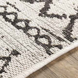 Close-up of the Westside Outdoor Area Rug. Black and white bohemian pattern, machine woven texture. Texture