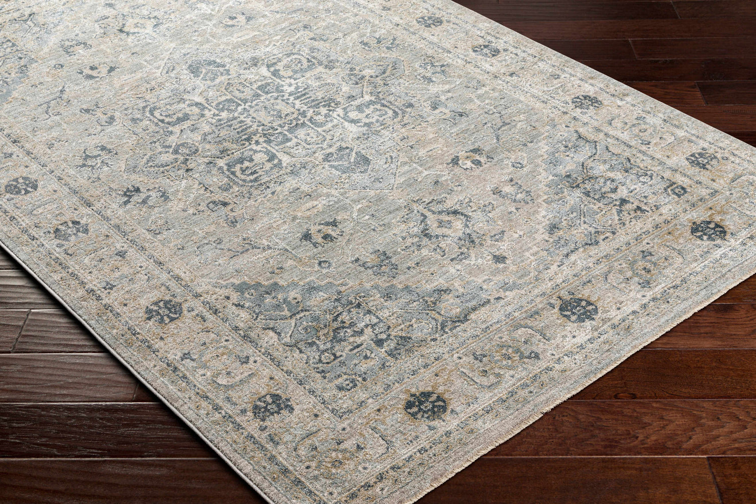 Close-up of the Whangamata Thick Luxe Boutique Rug featuring a traditional design in dusty sage, light gray, and taupe tones. Corner