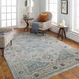 Living room scene with a Whangamata Thick Luxe Boutique Rug in light gray and teal, styled with neutral furniture and wood floors. Roomscene-Rectangle